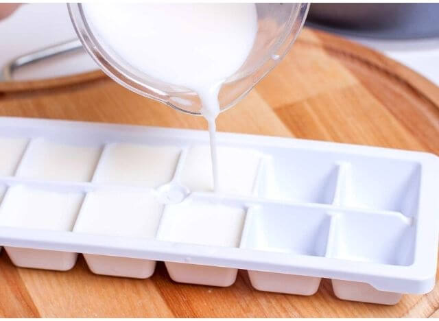 Pour soy milk into the ice tray